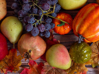 Autumn still life . Different fruits , vegetables an pumpkin ion the wooden table