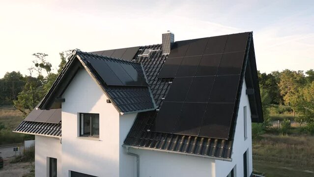 Newly built single-family house with solar panels in the afternoon sun