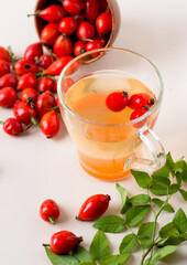 Cup with a drink made from rosehips, close-up, bowl with rosehips.