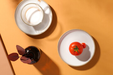 Ceramic dishes featured a cup of milk and red tomatoes. Beige background. Thanksgiving is to give thanks for the past year full of blessings