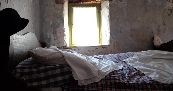 In the troglodyte rock house, an old bed by a window captures the essence of living as our forebears did