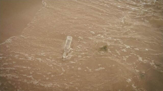 Glass bottle garbage trash in ocean. Used wine bottle floating in sea water. Environmental Issue. Human Impact Marine Pollution Ecology