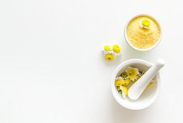 White mortar with pharmacy chamomile flowers for skin care spa products