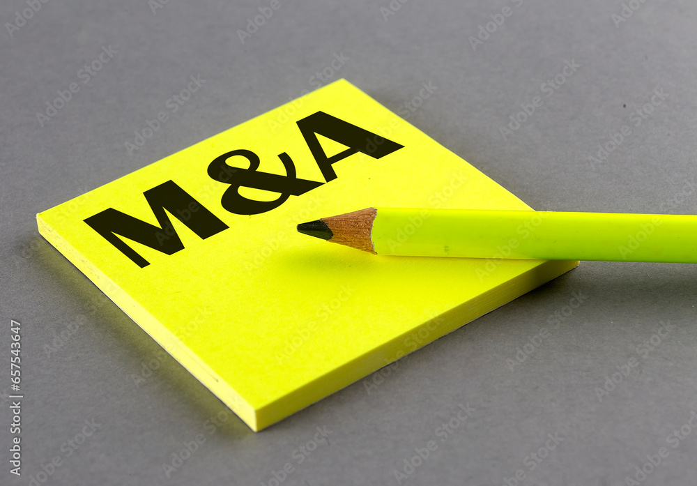 Poster m and a text written on a sticky on grey background