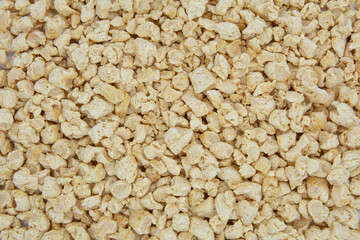 Raw dehydrated soy meat or soya textured chunks background. Top view.