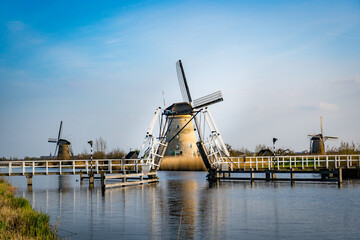 Fototapeta na wymiar dutch windmill across a river