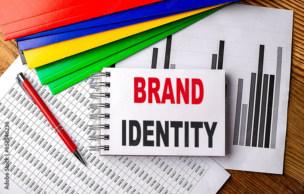 Aufkleber brand identity text on a notebook with pen, folder on a chart background
