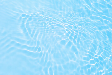 Fototapeta premium Defocus blurred transparent blue colored clear calm water surface texture with splashes reflection. Trendy abstract nature background. Water waves in sunlight with copy space. Blue watercolor shine.