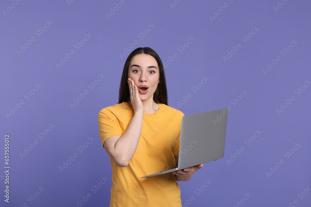 Sticker Surprised young woman with laptop on lilac background