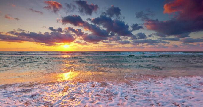 Sea horizon and scenic sunrise over splashing ocean waves and beach shore, tropical landscape 4K video