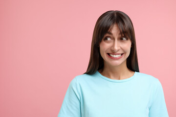 Embarrassed woman on pink background, space for text