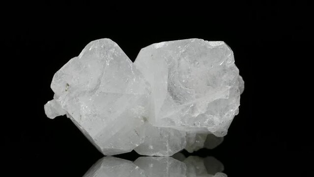 Zeolite crystals (aluminosilicate) specimen rotating slowly against a black background.