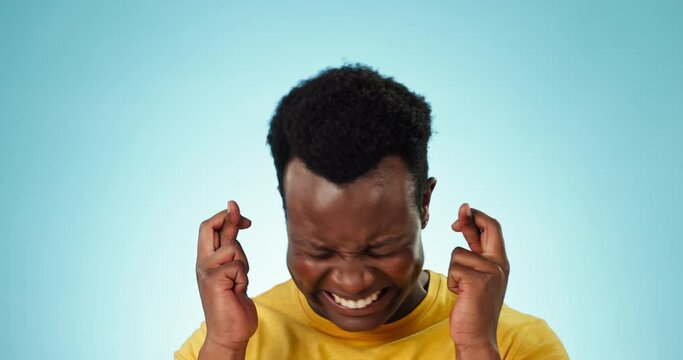 Man, wish and portrait with hands, fingers crossed and waiting for news, results or faith in god to help. Student, worry and spiritual person with crisis, problem or praying for blessing or hope