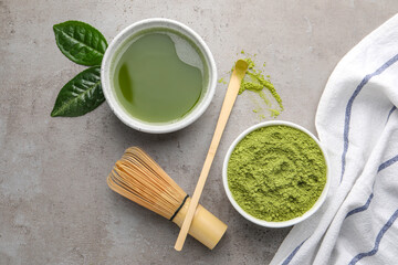 Flat lay composition with green matcha powder and fresh beverage on light grey table