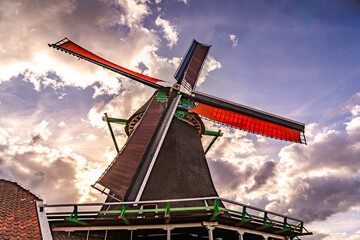 traditional dutch windmill against colorfull sky background