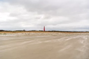Selbstklebende Fototapete Nordsee, Niederlande panorama panorama view on red lighthouse fom the beach of dutch island schiermonnikoog