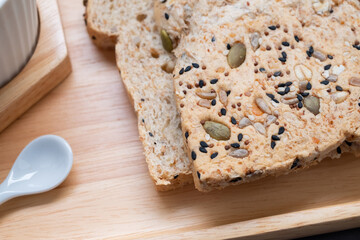Closeup to homemade grain bread for breakfast on wooden tray
