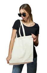 Young woman holding white textile eco tote bag. White eco shopping bag for mock up over transparent background