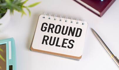 GROUND RULES text on a white folder on white background