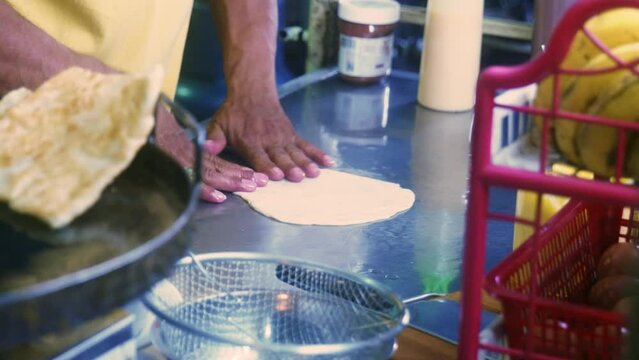 4K Cinematic cooking footage of a Thai chef preparing a traditionnal Thai dessert called Roti in a street market in Thailand