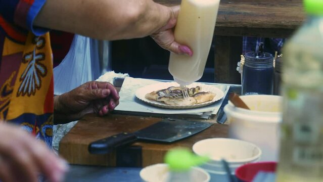 4K Cinematic cooking footage of a Thai chef preparing a traditionnal Thai dessert called Roti in a street market in Thailand