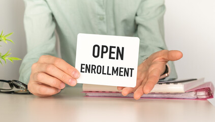 OPEN ENROLLMENT text on hand. Searching for information on the Internet concept. Web browser