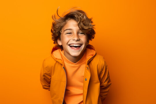 Cute boy child is happy and excited, opening eyes and mouth, Bright solid yellow color background