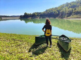 girl and canadian canoe on Lake Penne, Italy