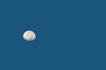 Nature scene of the moon in day time isolated with blue sky background - minimal abstract patterns.