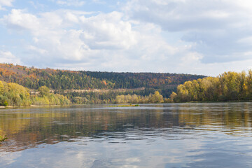 Autumn forest on the river bank. Autumn landscape