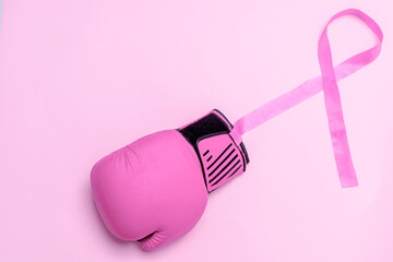 Breast cancer day, pink boxing glove with pink bow on pink background for international breast cancer day in October