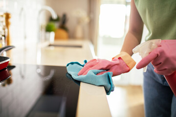 Close-up of a young woman cleaning her kitchen