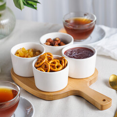 Fresh and bright continental breakfast table with jam, cheese, nuts and croissant. Vertical