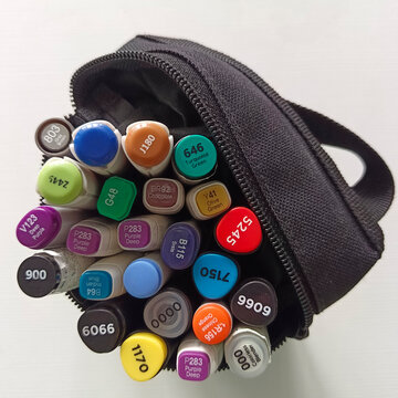 Scotch markers for drawing in a pencil case on a white table. View from above. Materials for artists.