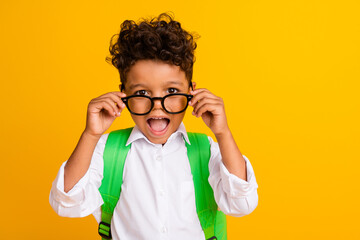 Photo of impressed astonished boy with backpack dressed white shirt touch glasses staring at sale...