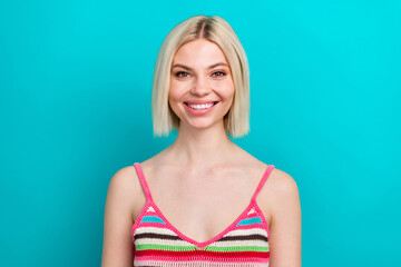 Photo portrait of pretty young girl toothy beaming smile look camera wear trendy striped outfit isolated on cyan color background
