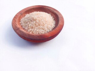granulated sugar in a wooden bowl isolated on a white background. cooking spices. sweet granules.