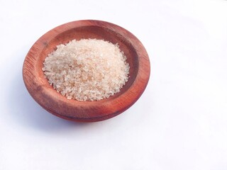 granulated sugar in a wooden bowl isolated on a white background. cooking spices. sweet granules.