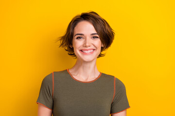 Portrait of friendly adorable nice woman with short hairdo wear khaki t-shirt smiling at camera...