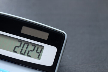 2024 on calculator screen. New year 2024 on the calculator display with copy space