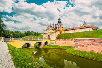 Nesvizh castle main entrance to castle is bridge with arches over pond