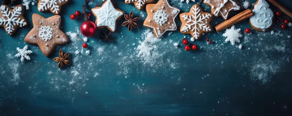 Fototapeten tasty decorated christmas cookies on blue background © krissikunterbunt