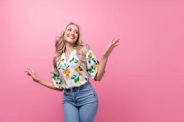 Deurstickers Photo of attractive young girlfriend blonde wavy hair dancing choose new spring outfit looking novelty isolated on pink color background © deagreez