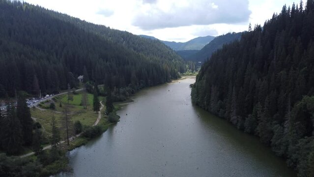 Scenic drone footage of Lacul Rosu, Romania. Fascinating aerial views of landscape, mountains and lake.