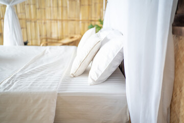 Fototapeta na wymiar bedroom with wooden furniture and white bedclothes.