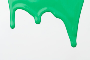 Acrylic paint blot, chaotic brushstroke, spot flowing on white paper background. Creative green color backdrop, fluid art.
