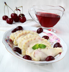 traditional dumplings with cherries on a plate