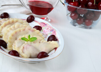 traditional dumplings with cherries on a plate