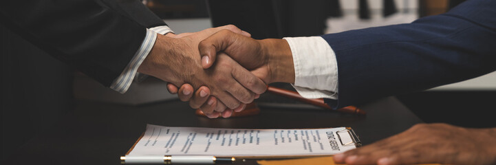 Lawyer handshake accepting agreement and accepting money envelope from businessman after discussing...