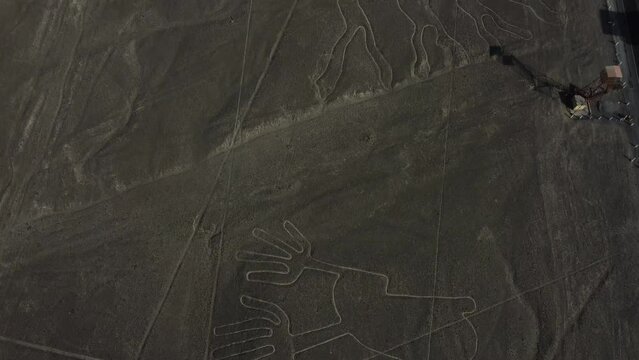 Nazca lines next to the Panamerican highway with the viewing tower next to the tarmac road